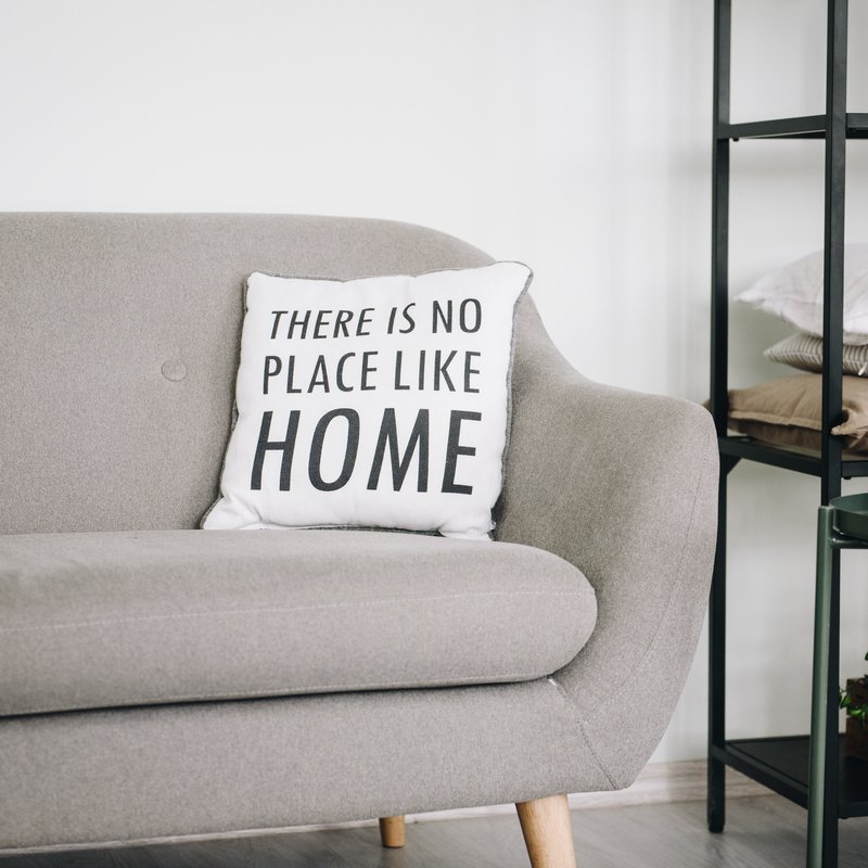 grey couch with pillow
